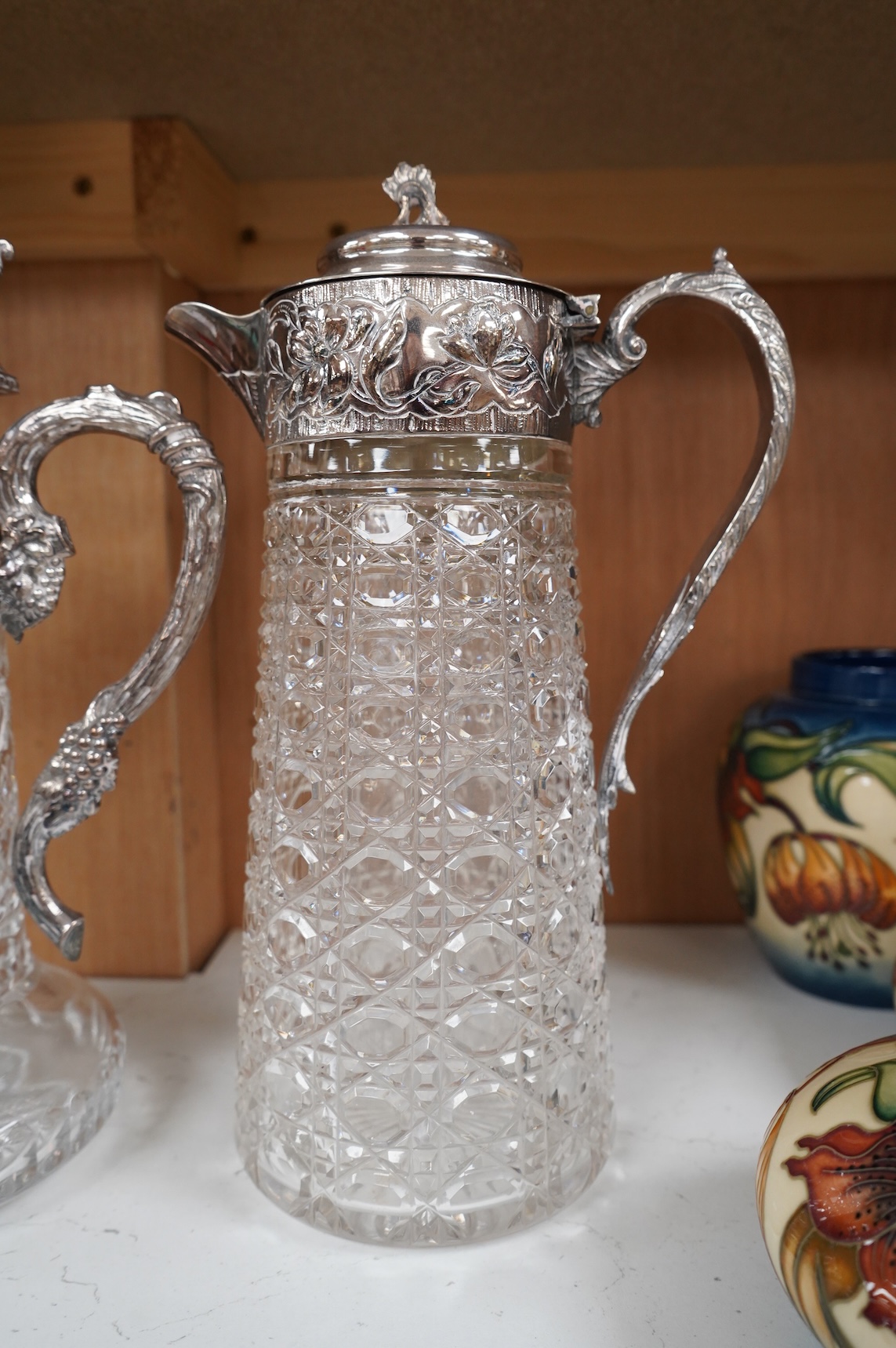 A silver plate mounted glass lemonade jug and a similar claret jug, largest 29cm high